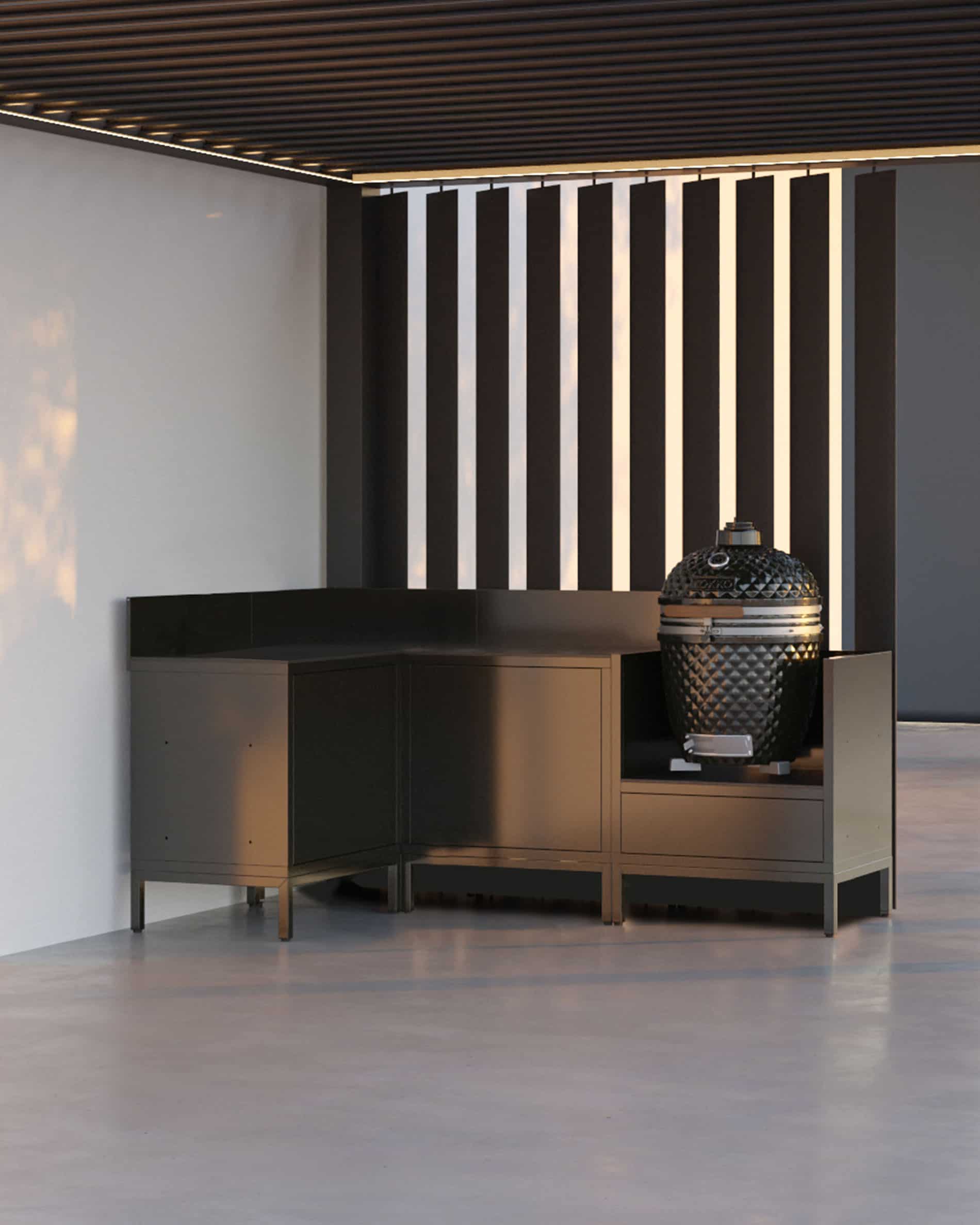 Cuisine pilotis composée de quatre modules avec configuration d’angle, plan de travail continu et module dédié au kamado, installée sous une pergola contemporaine avec claustras verticaux sur terrasse extérieure.